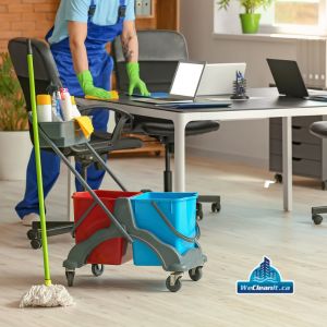 commercial office cleaners sanitizing desk